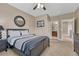 This bedroom has a ceiling fan and natural light from the window overlooking the ensuite bathroom at 8707 Windhaven Dr, Parker, CO 80134