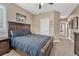A large bed is featured in this bedroom, complete with a ceiling fan and a full ensuite bathroom at 8707 Windhaven Dr, Parker, CO 80134