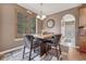 Cozy dining area featuring a unique wood table set, complemented by natural light from the window with wood shutters at 8707 Windhaven Dr, Parker, CO 80134