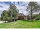A large house with two stories and a well-maintained lawn with mature trees at 8707 Windhaven Dr, Parker, CO 80134