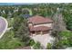Charming home featuring a two-car garage, basketball hoop, and mature trees at 8707 Windhaven Dr, Parker, CO 80134