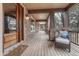 Inviting covered front porch with stone pillars and a welcoming entrance at 8707 Windhaven Dr, Parker, CO 80134