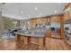 Well-equipped kitchen featuring an island with seating, granite countertops and stainless appliances at 8707 Windhaven Dr, Parker, CO 80134