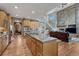 Spacious kitchen with island, stainless appliances, and open layout to living room and dining area at 8707 Windhaven Dr, Parker, CO 80134