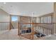 View of an open-concept living room featuring a stone fireplace and mantle, hardwood floors, and large windows at 8707 Windhaven Dr, Parker, CO 80134