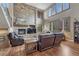 Comfortable living room features a stone fireplace and large windows with plantation shutters at 8707 Windhaven Dr, Parker, CO 80134