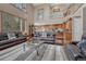 Open-concept living room and kitchen with hardwood floors and neutral colors at 8707 Windhaven Dr, Parker, CO 80134