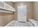 Neutral toned mudroom with tile flooring, bench and coat rack storage adjacent to the home's entrance at 8707 Windhaven Dr, Parker, CO 80134