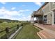 Green backyard features manicured lawn, artificial turf, wooden fence, and deck with peaceful views at 3871 Starry Night Loop, Castle Rock, CO 80109