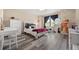 Bright bedroom with chair swing, desk, dresser, and stylish decor at 3871 Starry Night Loop, Castle Rock, CO 80109