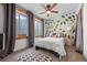 Cozy bedroom with a nature-inspired mural, plush rug, and natural light from the window at 3871 Starry Night Loop, Castle Rock, CO 80109