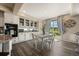 Eat-in kitchen boasts white cabinetry, stainless appliances, and sliding glass doors to the outdoor deck at 3871 Starry Night Loop, Castle Rock, CO 80109