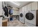 Well-organized laundry room with modern appliances, ample storage, and a convenient folding area at 3871 Starry Night Loop, Castle Rock, CO 80109