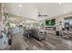 Open-concept living room, hardwood floors, and seamless flow to the kitchen and dining area at 3871 Starry Night Loop, Castle Rock, CO 80109