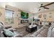 Comfortable living room with lots of seating, fireplace, hardwood floors, ceiling fan and bright natural light at 3871 Starry Night Loop, Castle Rock, CO 80109