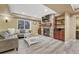Cozy basement living area featuring a stone fireplace, built-in shelves, and a comfortable sofa at 10375 Knollside Dr, Parker, CO 80134