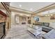 Basement area features a fireplace, seating area, bar, and wood-look flooring for entertaining at 10375 Knollside Dr, Parker, CO 80134