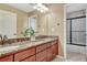Bathroom featuring a double vanity, granite countertop, and a separate shower and toilet room at 10375 Knollside Dr, Parker, CO 80134