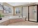 This primary bathroom includes a corner bathtub and separate glass shower at 10375 Knollside Dr, Parker, CO 80134