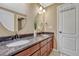 Bathroom with a double vanity, granite countertop, and wood cabinetry offers functionality and style at 10375 Knollside Dr, Parker, CO 80134