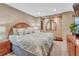 Bedroom featuring neutral walls, carpet, and a bed with patterned linens create a relaxing ambiance at 10375 Knollside Dr, Parker, CO 80134