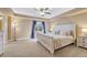 Well-lit bedroom with neutral tones, a tray ceiling, and a large window overlooking a yard at 10375 Knollside Dr, Parker, CO 80134