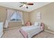 Bedroom featuring carpeted floors, a ceiling fan, a single bed, and a window with curtains at 10375 Knollside Dr, Parker, CO 80134