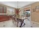 A dining area features a view to the patio, a stylish chandelier, a granite counter and decorative signage at 10375 Knollside Dr, Parker, CO 80134