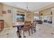 Inviting dining area features a modern chandelier and natural light, seamlessly connecting indoor and outdoor spaces at 10375 Knollside Dr, Parker, CO 80134