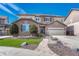 A stately two-story residence featuring a well-kept lawn, complemented by stone accents and a side-entry two-car garage at 10375 Knollside Dr, Parker, CO 80134
