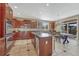 The kitchen features stainless appliances, a center island, dark wood cabinetry and a window overlooking the backyard at 10375 Knollside Dr, Parker, CO 80134