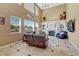 Spacious living room showcases a cozy fireplace, complemented by large windows and neutral decor at 10375 Knollside Dr, Parker, CO 80134