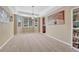A spacious room is carpeted and features a large bay window, a unique chandelier and artistic wall decorations at 10375 Knollside Dr, Parker, CO 80134