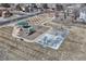 Aerial view of a community playground with a slide, swings, picnic shelter, and basketball court at 10375 Knollside Dr, Parker, CO 80134