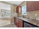 This home features a wet bar with a mini fridge, sink, and window at 10375 Knollside Dr, Parker, CO 80134