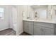 This bathroom features a neutral vanity with a white countertop paired with wood floors and a shower-tub combo at 2153 Flower Blossom Ave, Brighton, CO 80601