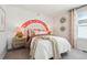 Charming bedroom with colorful rainbow wall art and neutral decor at 2153 Flower Blossom Ave, Brighton, CO 80601