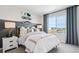 This bedroom features a stylish design with modern decor, a large window, and cool skateboards on the wall at 2153 Flower Blossom Ave, Brighton, CO 80601