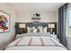 Stylishly decorated bedroom featuring skater decor, soft ambient lighting, and neutral colored bedding for a calm space at 2153 Flower Blossom Ave, Brighton, CO 80601