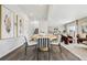 Open-concept dining area with modern chairs and hardwood floors, seamlessly connected to the kitchen and living spaces at 2153 Flower Blossom Ave, Brighton, CO 80601
