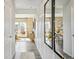 Bright hallway featuring modern decor, hardwood floors, and an open view to the living and dining areas at 2153 Flower Blossom Ave, Brighton, CO 80601