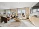 Bright living room featuring modern decor, a large window, and comfortable seating arrangements at 2153 Flower Blossom Ave, Brighton, CO 80601