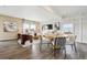 Bright living room with dining area, hardwood floors, and modern decor at 2153 Flower Blossom Ave, Brighton, CO 80601