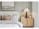 A view of the bedside table in the neutral tone main bedroom at 2153 Flower Blossom Ave, Brighton, CO 80601