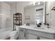 Bright bathroom featuring a tub, a toilet, a vanity, a mirror, and natural light at 15538 Native Willow Dr, Monument, CO 80132