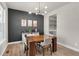 This is a dining room with a modern light fixture and dark accent wall with three modern art pieces at 15538 Native Willow Dr, Monument, CO 80132