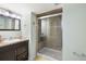 Bathroom featuring a tiled shower with glass doors, modern vanity, and updated fixtures at 930 Button Rock Dr # 28, Longmont, CO 80504