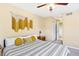 Comfortable bedroom featuring neutral colored walls, patterned bedding and a ceiling fan at 930 Button Rock Dr # 28, Longmont, CO 80504