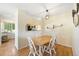 Bright dining area featuring hardwood floors and an open view to the kitchen at 930 Button Rock Dr # 28, Longmont, CO 80504