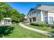 Manicured front yard with lush green grass, walking path, and gazebo at 930 Button Rock Dr # 28, Longmont, CO 80504